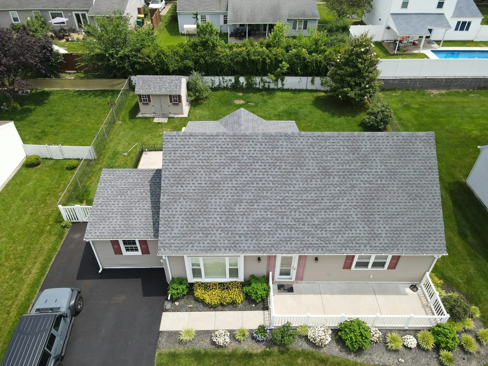 Aerial view of a gray shingle roof and its ridge lines — illustrative stock photo