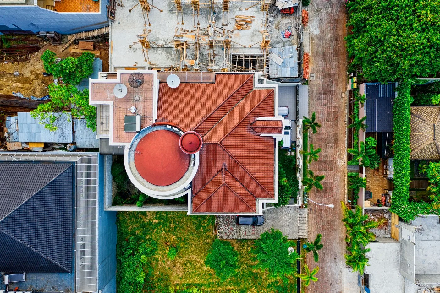 Overhead view of red tile roof planes and valleys — illustrative stock photo